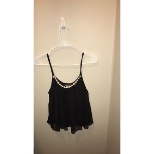 Black tank top with flowers lining the top